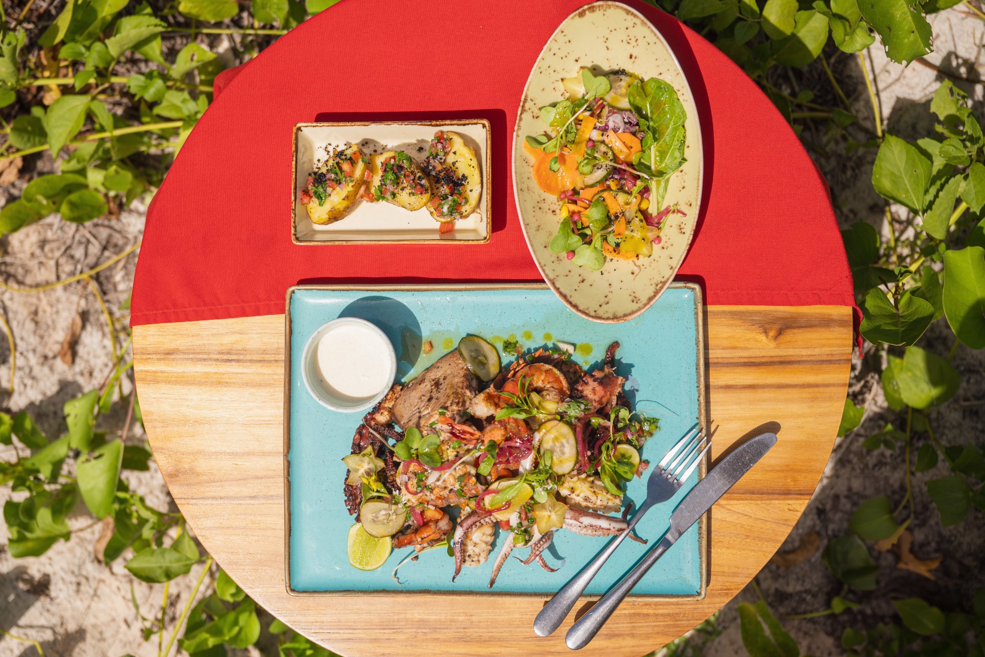 Colourful fresh dishes served on a table by the beach
